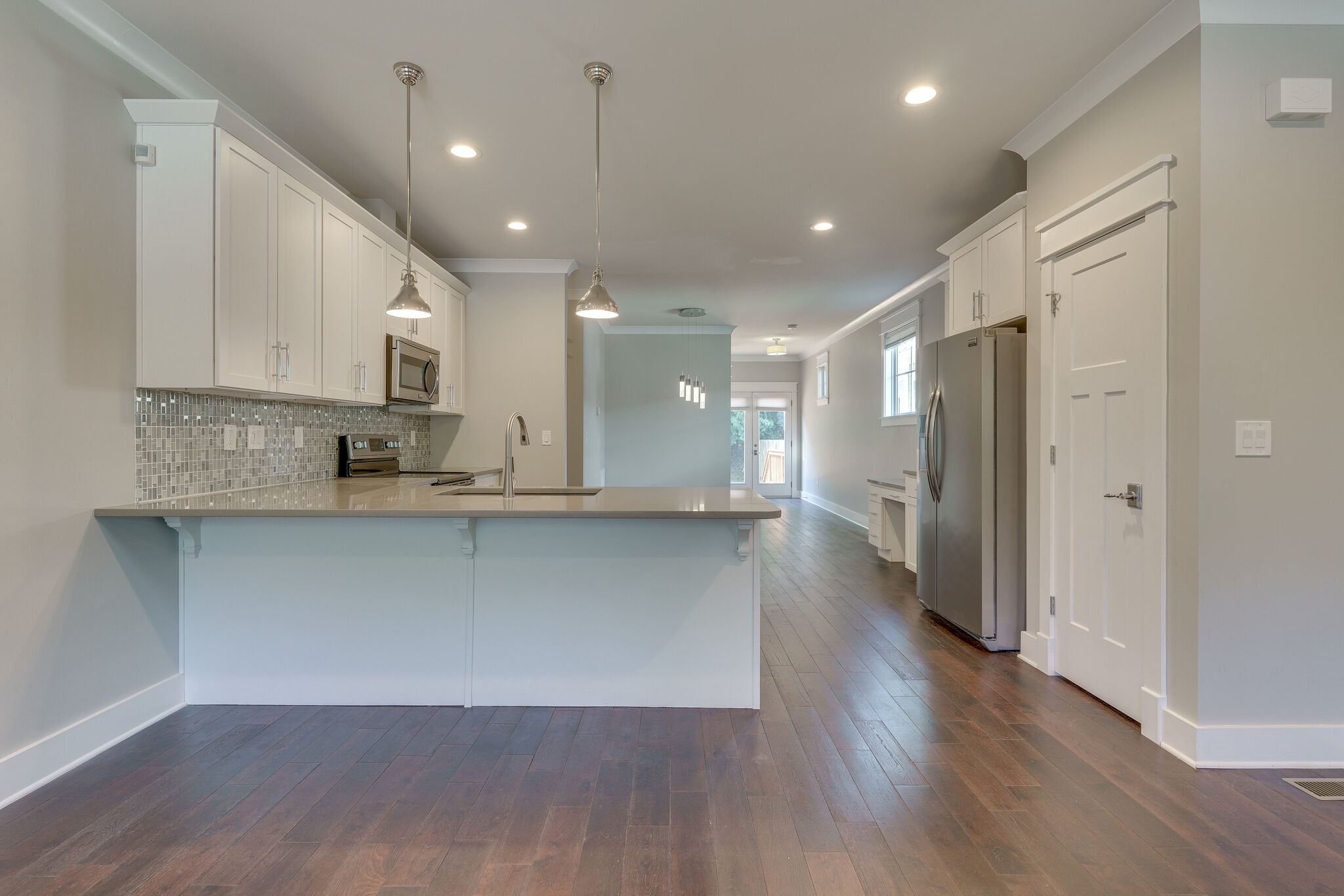 1711 Ridley Boulevard Nashville, TN 37203 - Photo 32 of 49 a open kitchen with stainless steel appliances granite countertop a refrigerator a sink dishwasher a stove and white cabinets with wooden floor