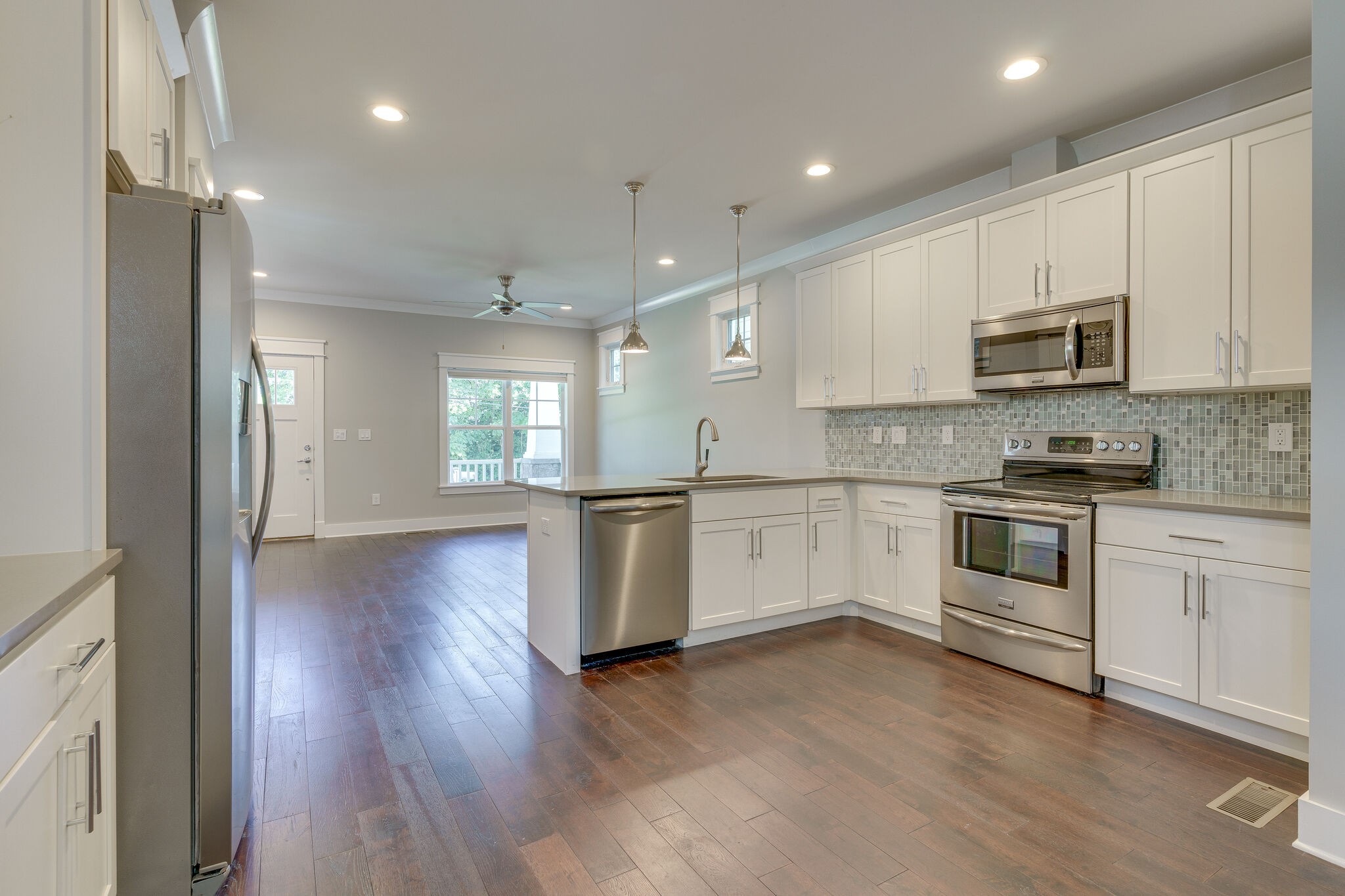 1711 Ridley Boulevard Nashville, TN 37203 - Photo 33 of 49 a kitchen with granite countertop white cabinets and white appliances