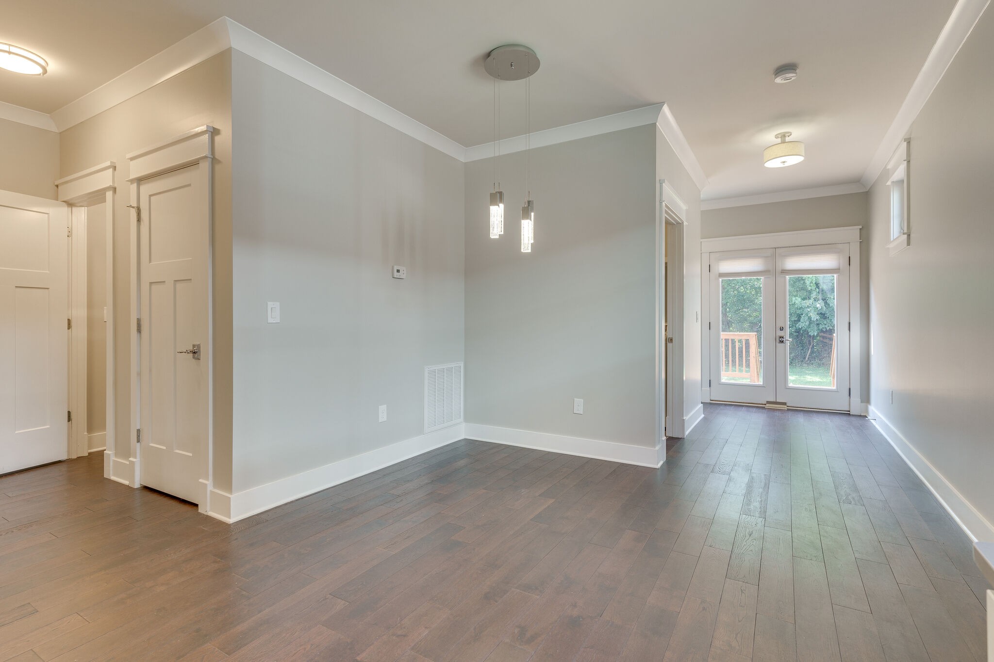 1711 Ridley Boulevard Nashville, TN 37203 - Photo 38 of 49 an empty room with wooden floor and windows