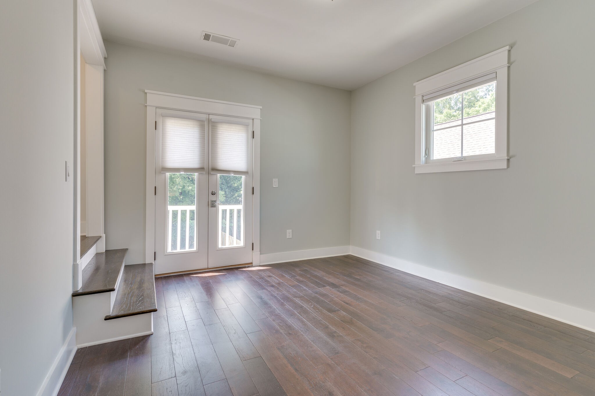 1711 Ridley Boulevard Nashville, TN 37203 - Photo 42 of 49 a view of an empty room with wooden floor and a window