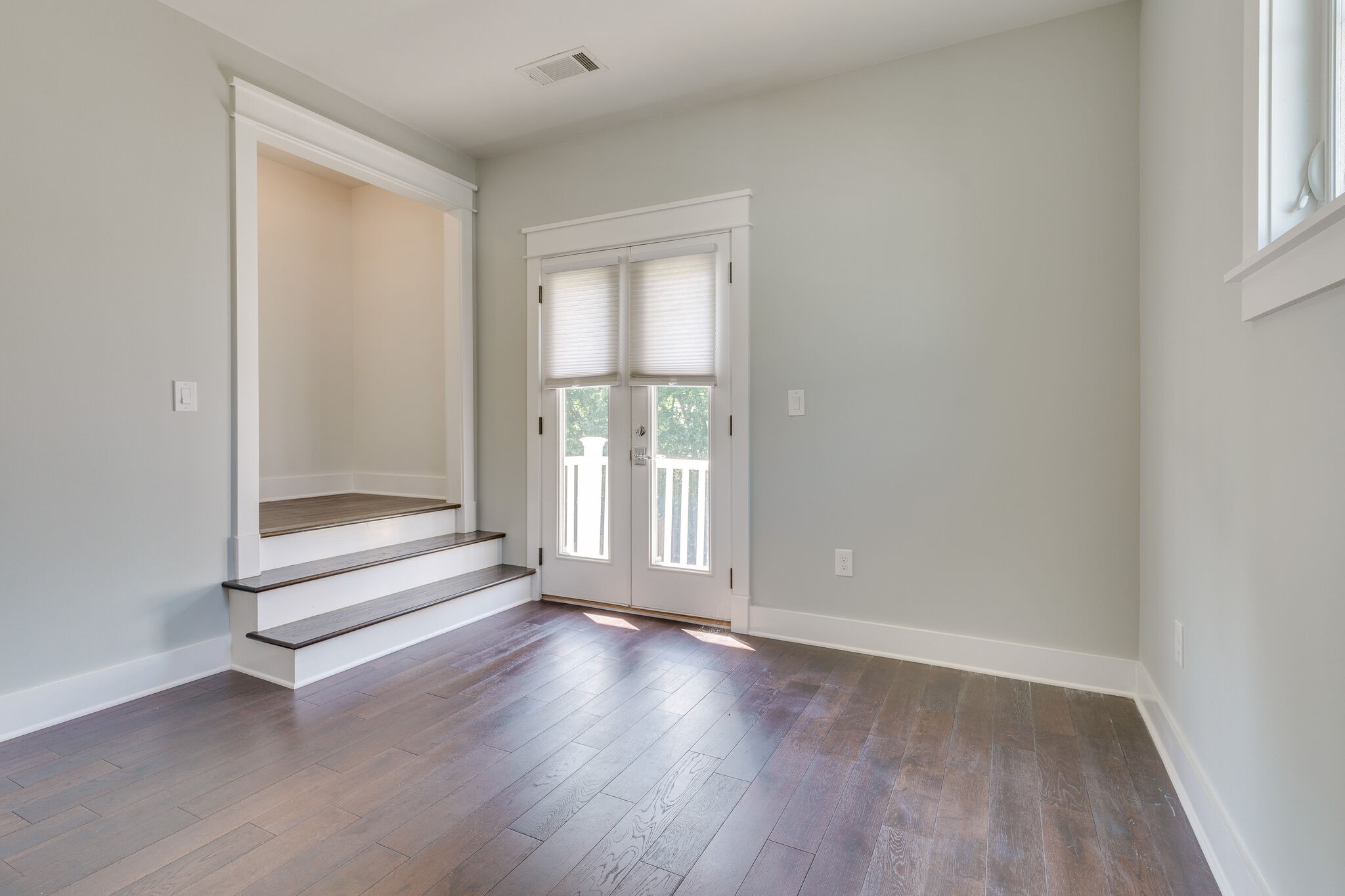 1711 Ridley Boulevard Nashville, TN 37203 - Photo 43 of 49 an empty room with wooden floor and windows