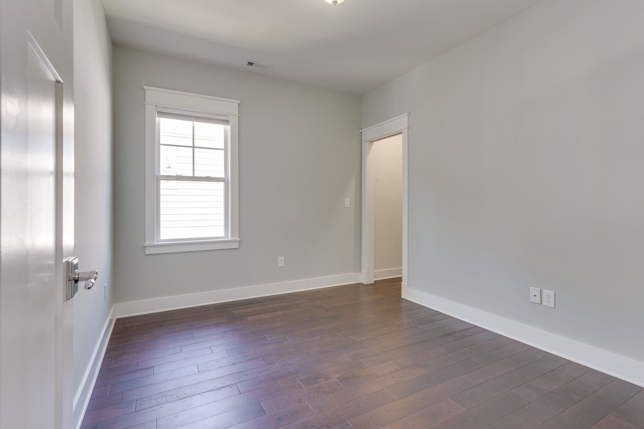 1711 Ridley Boulevard Nashville, TN 37203 - Photo 46 of 49 an empty room with wooden floor and windows