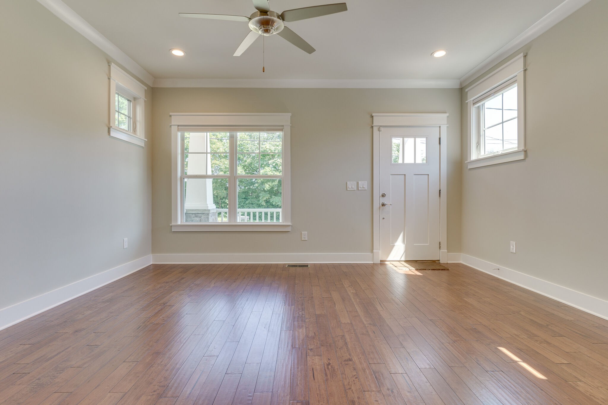 1711 Ridley Boulevard Nashville, TN 37203 - Photo 7 of 49 a view of an empty room with wooden floor and a window