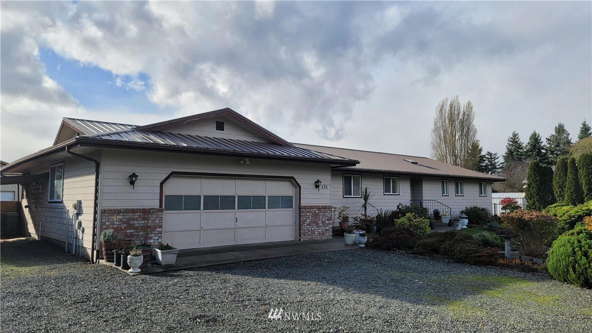 171 Mantle Road Sequim, WA 98382 - Photo 1 of 34 a front view of a house with garden