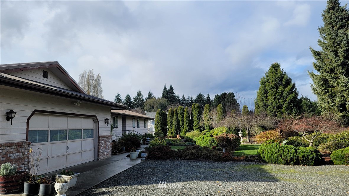 171 Mantle Road Sequim, WA 98382 - Photo 3 of 34 a front view of a house with a yard