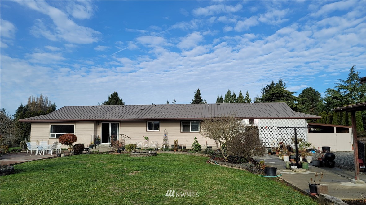 171 Mantle Road Sequim, WA 98382 - Photo 25 of 34 a front view of a house with a garden