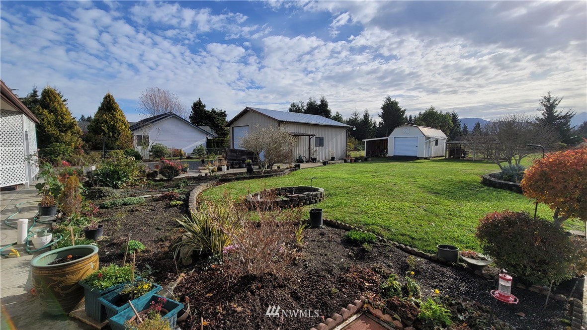 171 Mantle Road Sequim, WA 98382 - Photo 27 of 34 a view of a garden with a house in the background