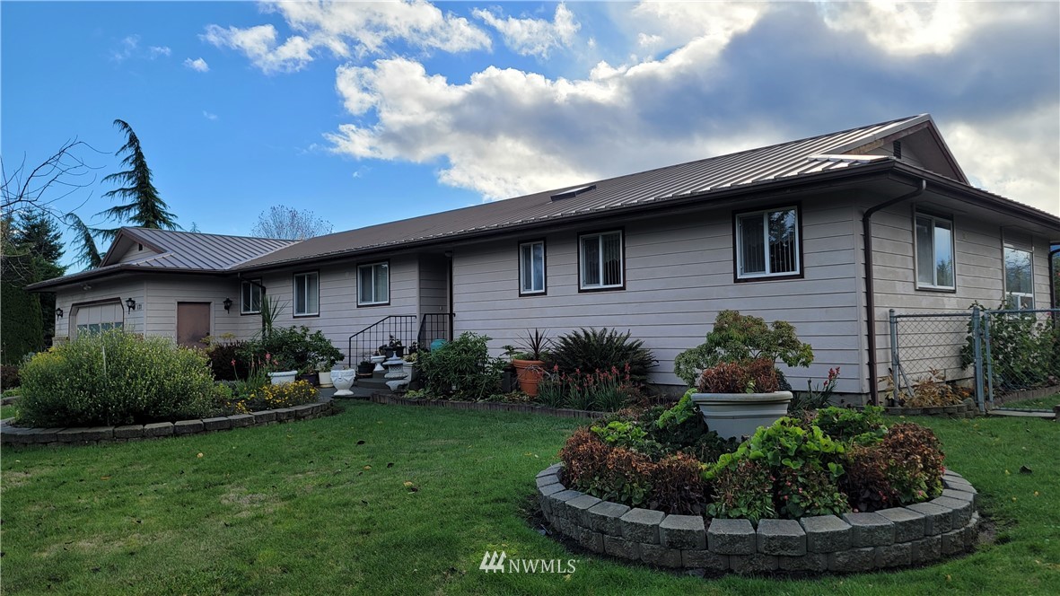 171 Mantle Road Sequim, WA 98382 - Photo 30 of 34 a view of a house with a yard patio and a garden