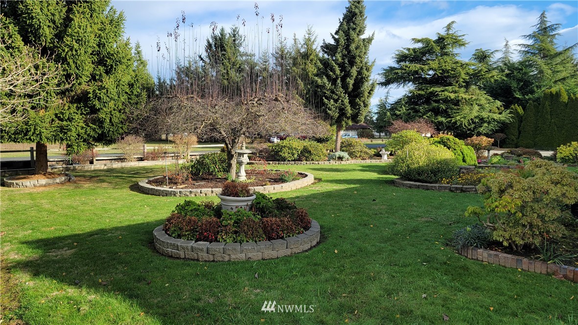 171 Mantle Road Sequim, WA 98382 - Photo 31 of 34 a view of a fountain in a yard with large trees