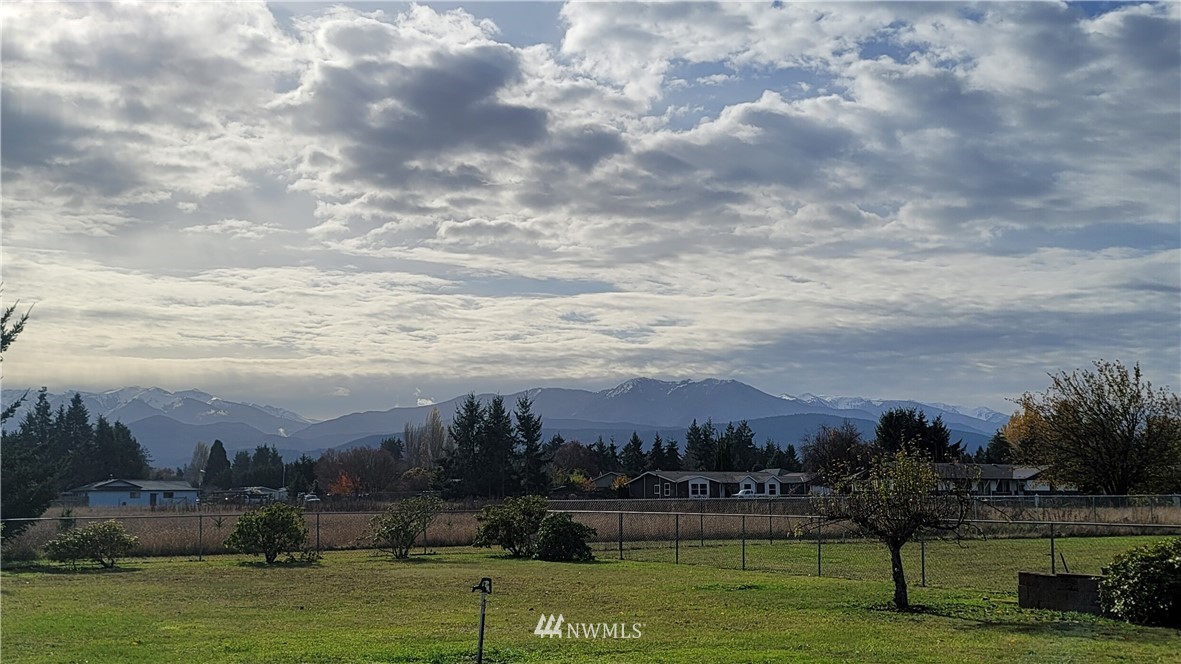 171 Mantle Road Sequim, WA 98382 - Photo 32 of 34 a view of a city with an ocean and houses in the back