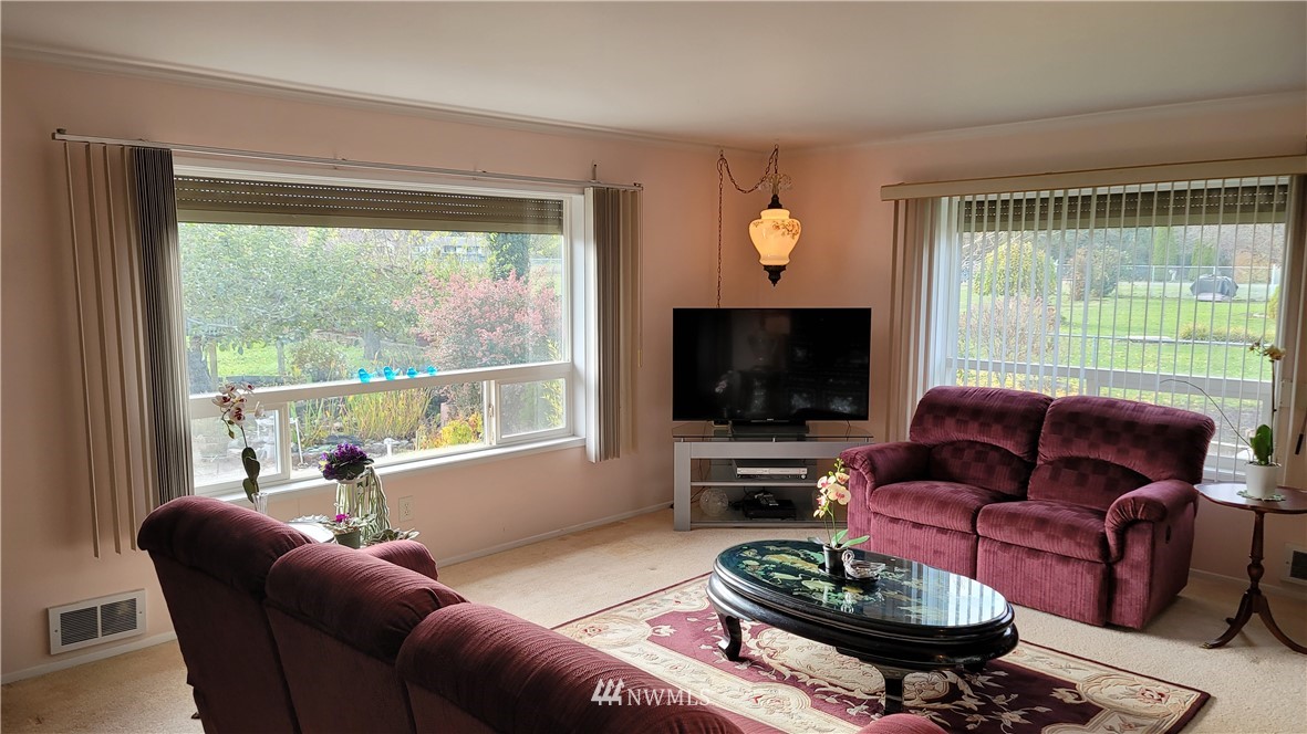 171 Mantle Road Sequim, WA 98382 - Photo 7 of 34 a living room with furniture a flat screen tv and a large window