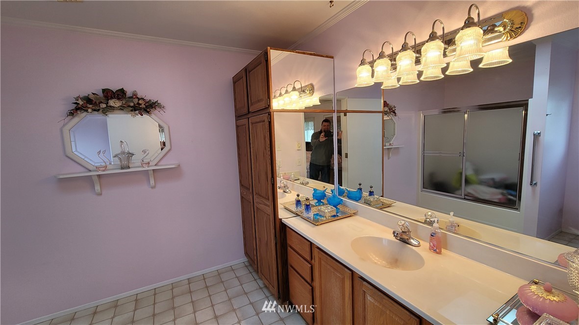 171 Mantle Road Sequim, WA 98382 - Photo 10 of 34 a bathroom with a sink vanity and mirror