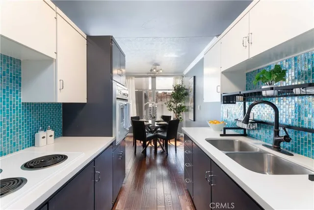 a kitchen with sink cabinets and dining table