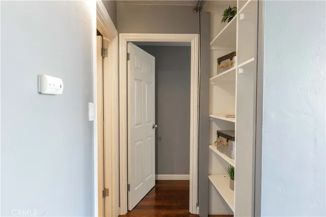 a view of a hallway with wooden floor and entryway