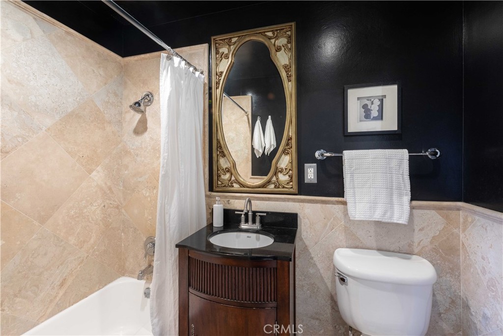 100 Atlantic Avenue, Unit 902 Long Beach, CA 90802 - Photo 15 of 28 a bathroom with a toilet sink and mirror