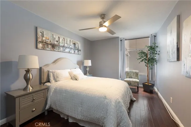 a bedroom with a large bed and a chandelier