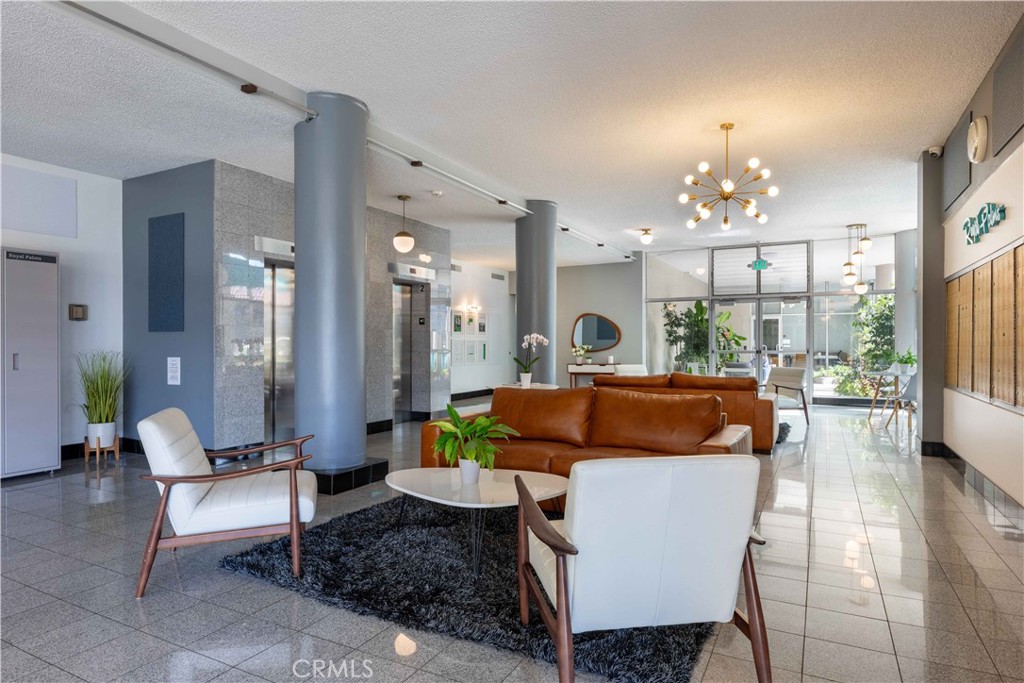 100 Atlantic Avenue, Unit 902 Long Beach, CA 90802 - Photo 26 of 28 a living room with furniture and a chandelier