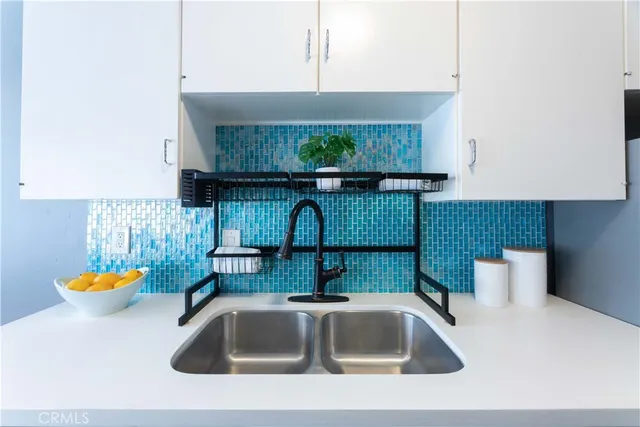 a sink with a granite top and a potted plant