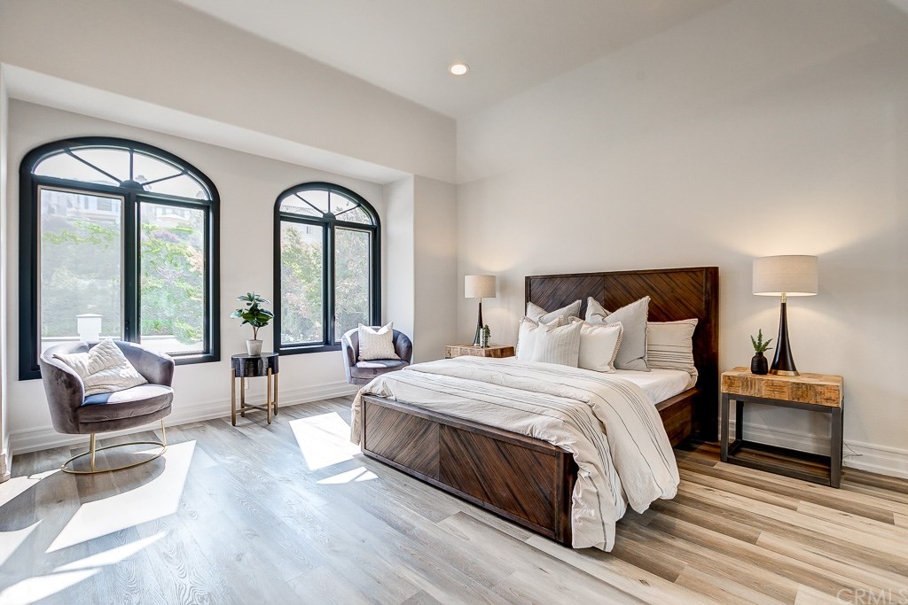 11 Marbella Dana Point, CA 92629 - Photo 19 of 50 a spacious bedroom with a bed and a large mirror