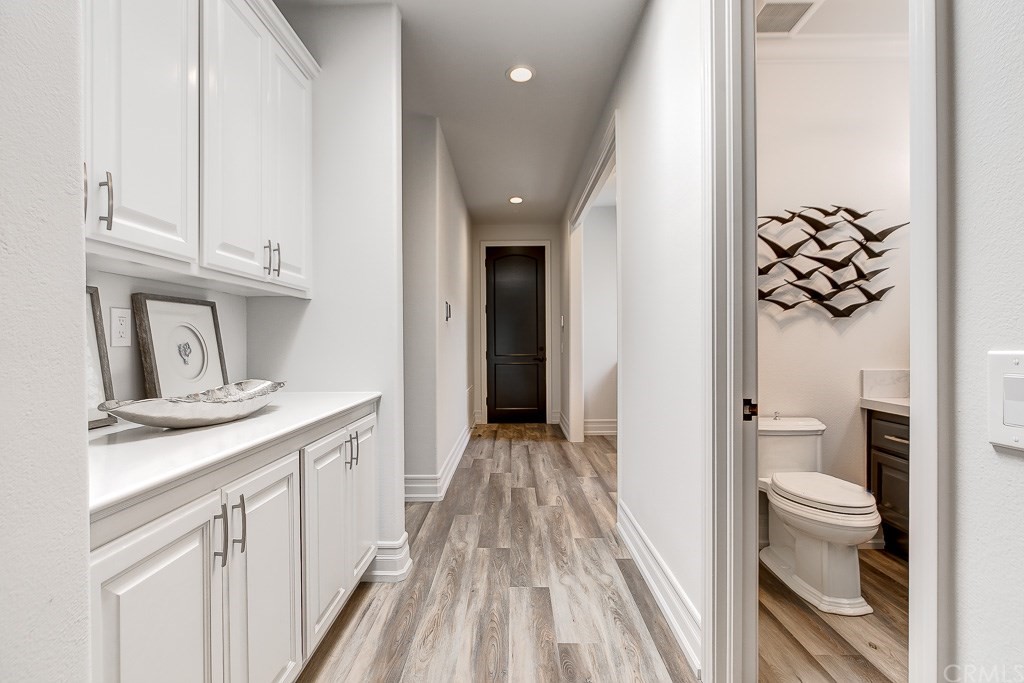 11 Marbella Dana Point, CA 92629 - Photo 23 of 50 a view of a hallway with wooden floor and a bathroom