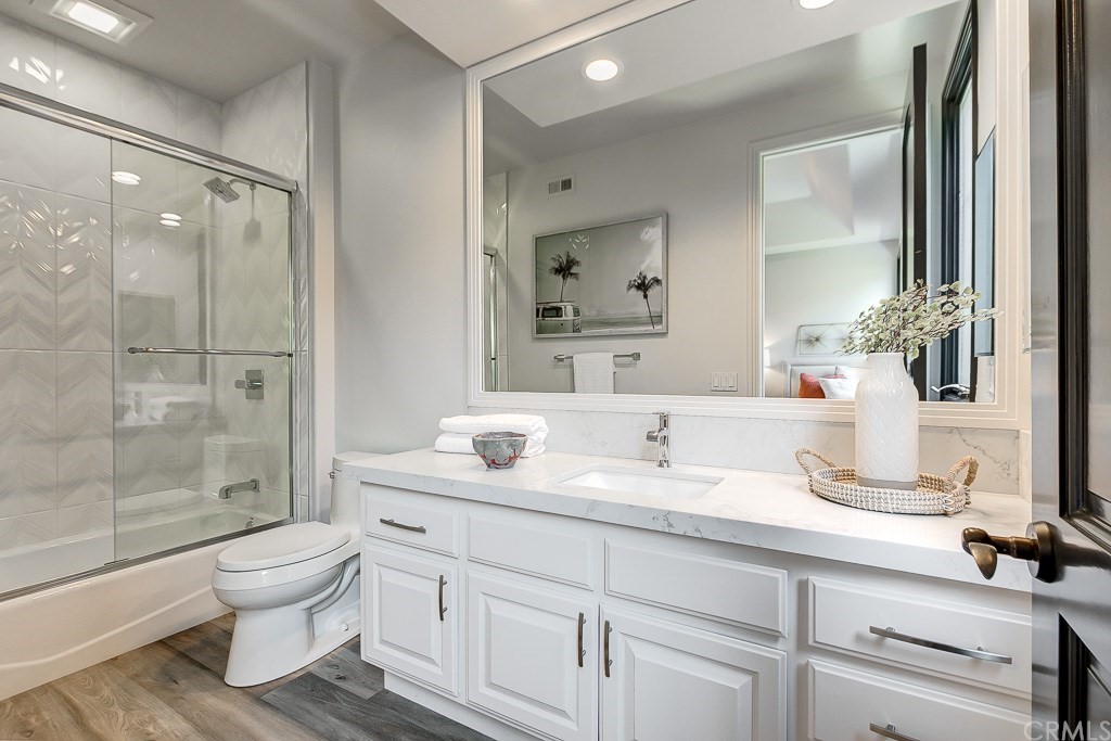 11 Marbella Dana Point, CA 92629 - Photo 25 of 50 a bathroom with a granite countertop sink toilet a large mirror a vanity and shower