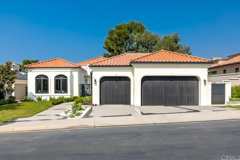 11 Marbella Dana Point, CA 92629 - Photo 47 of 50 a front view of a house with a yard and garage
