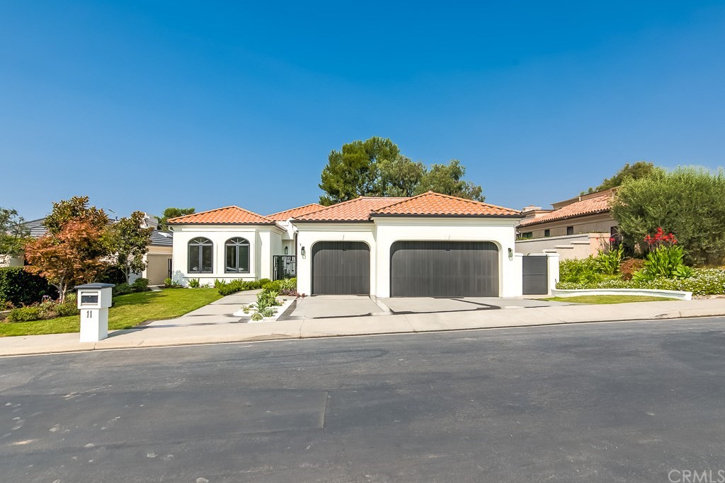 11 Marbella Dana Point, CA 92629 - Photo 48 of 50 a front view of a house with a yard and garage
