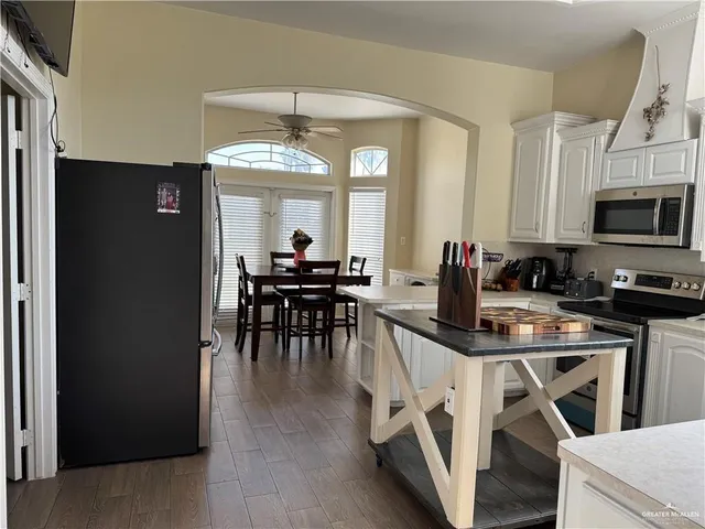 a view of a dining room with furniture and a chandelier