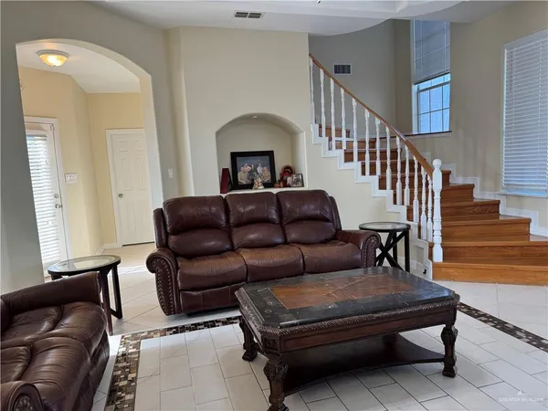 a living room with furniture and a piano
