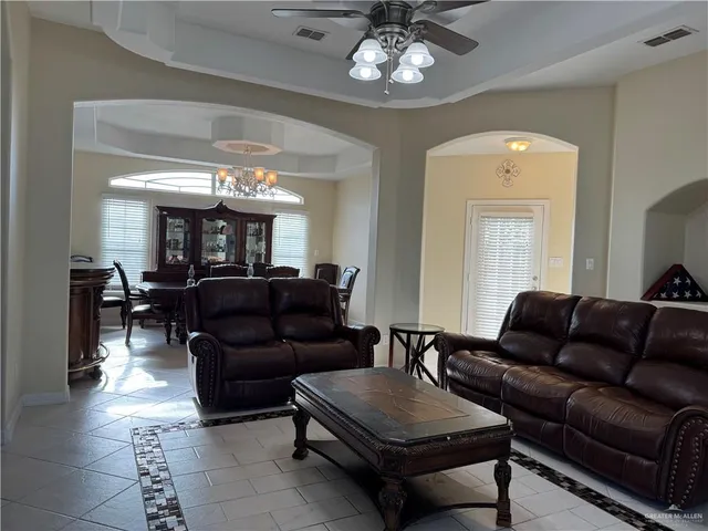 a living room with furniture and a chandelier