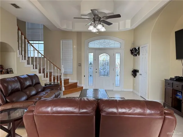 a living room with furniture and a chandelier