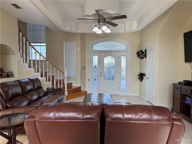 a living room with furniture and a chandelier