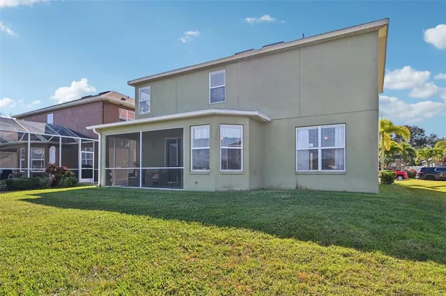 a view of a house with a yard and porch
