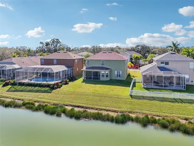 an aerial view of residential houses with outdoor space and swimming pool