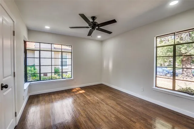 wooden floor in an empty room with a window