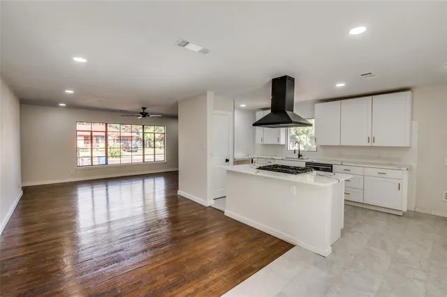 a kitchen with a sink stainless steel appliances and cabinets