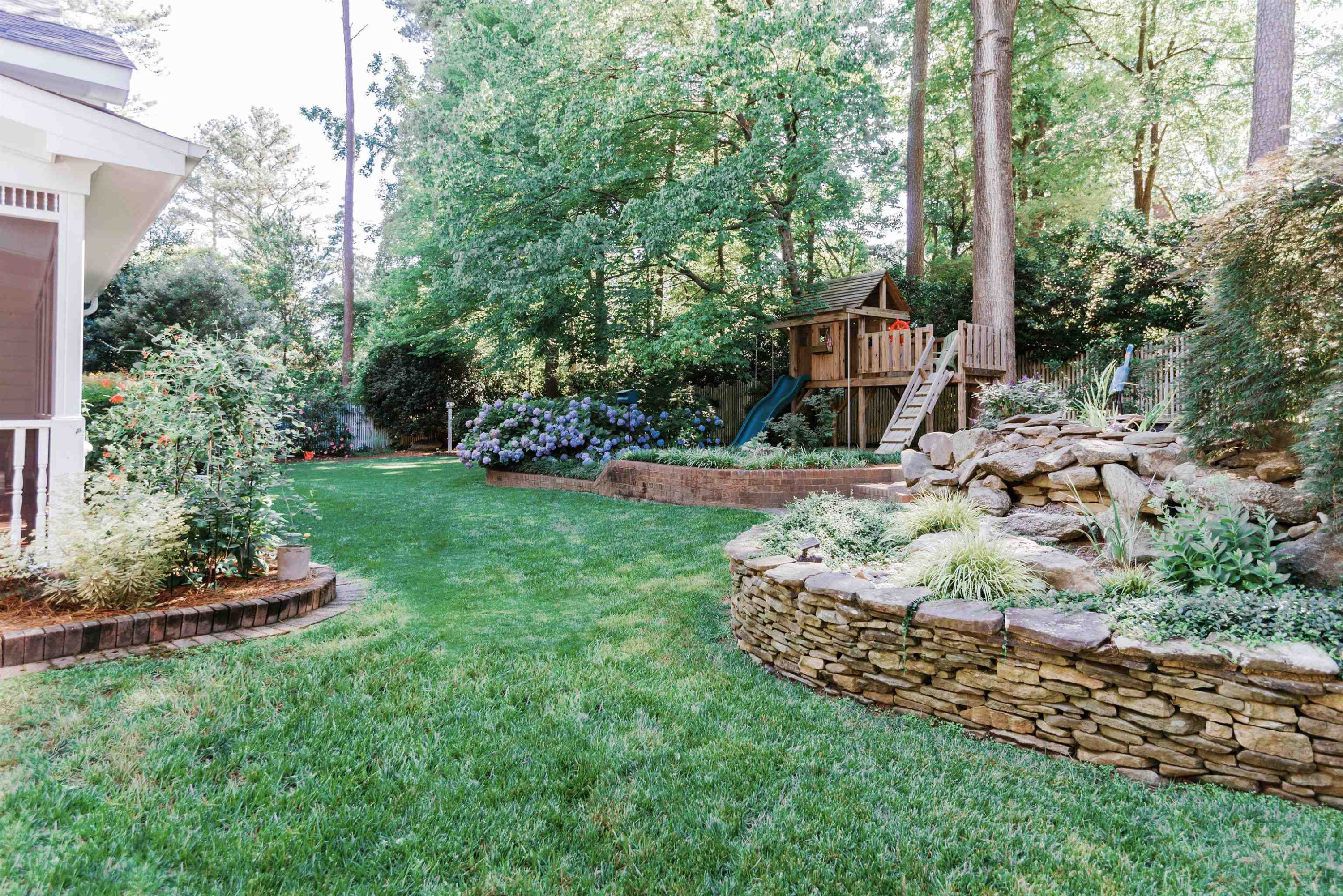 6928 Slade Hill Road Raleigh, NC 27615 - Photo 40 of 46 Well manicured yard with landscape lighting and irrigation. Backyard