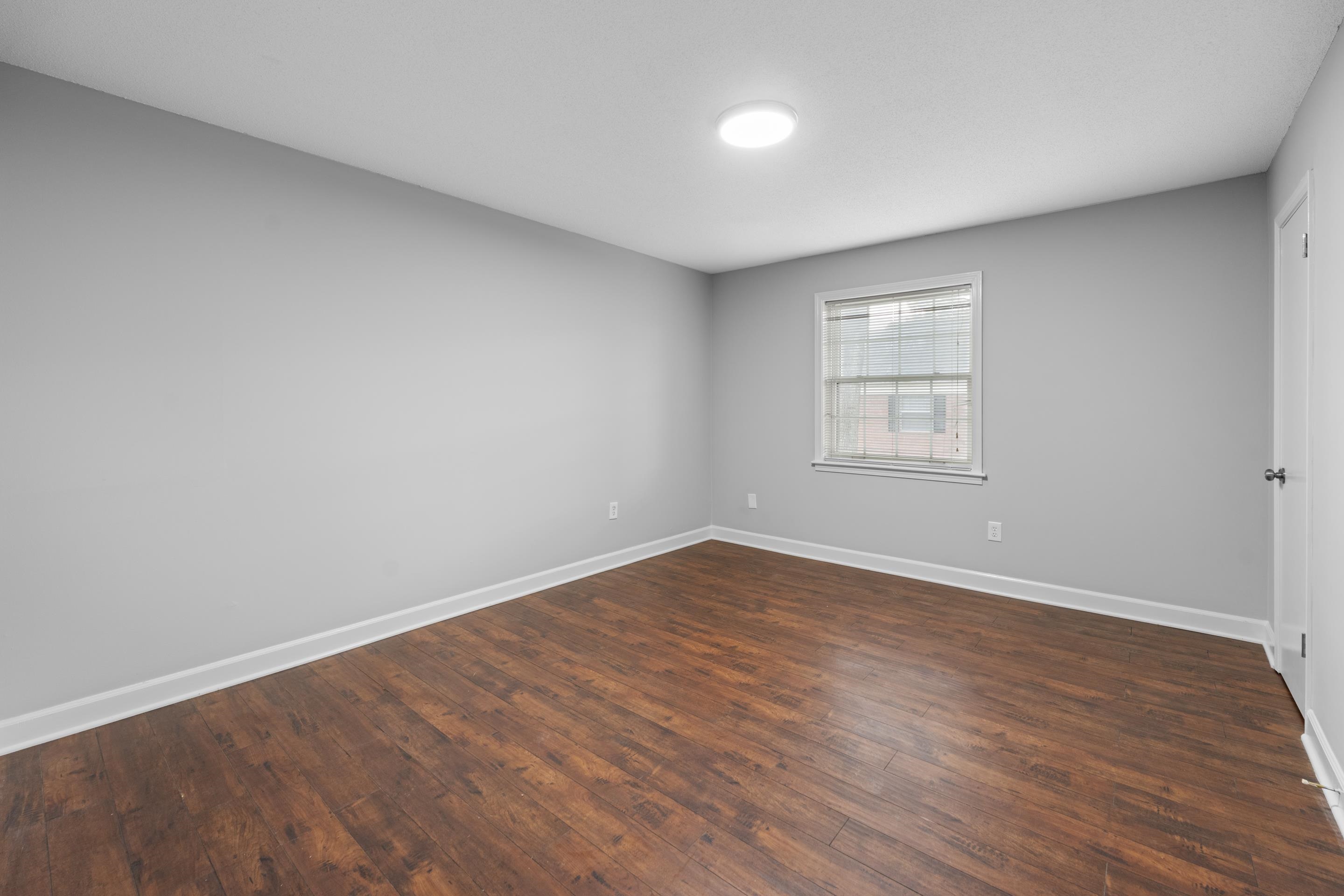 5686 Quince Road, Unit 3 Memphis, TN 38119 - Photo 8 of 17 Spare room featuring baseboards and dark wood-style flooring