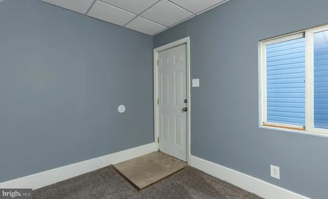 a view of an empty room with windows