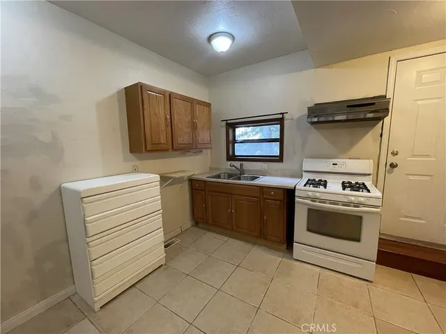 a kitchen with a stove sink and cabinets