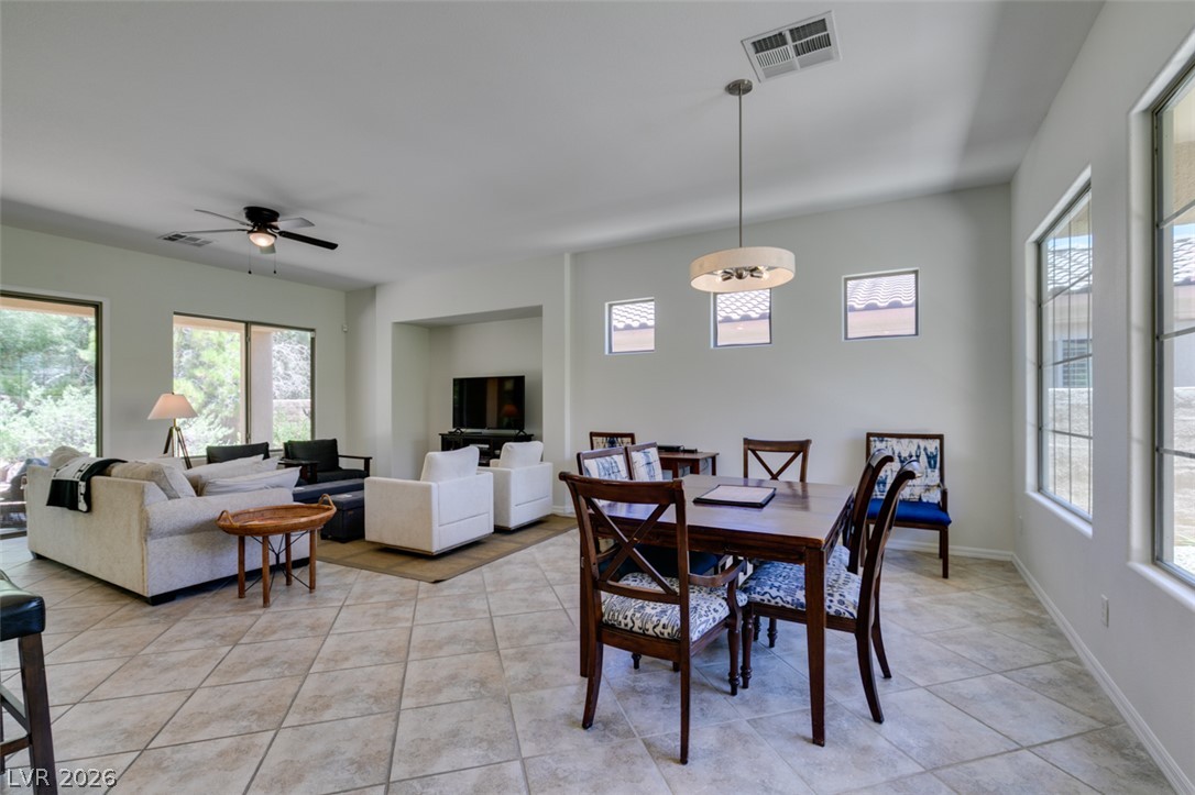 8 Kennesaw Road Henderson, NV 89052 - Photo 6 of 44 An open-concept living and dining area features abundant natural light and cool tile flooring.