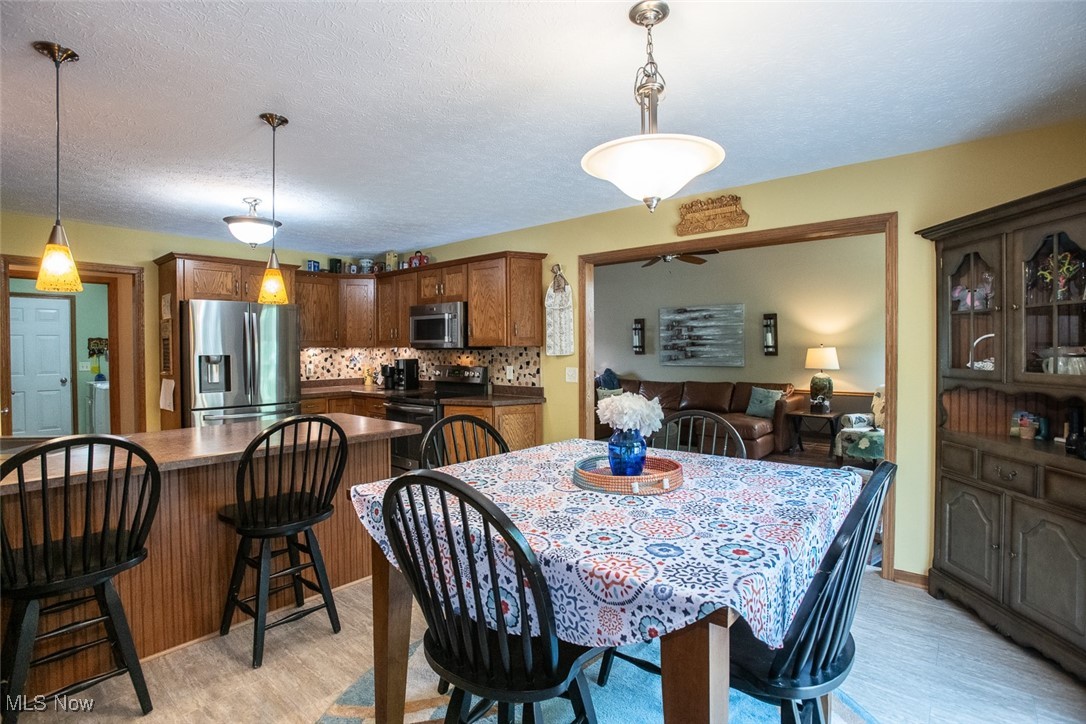 126 Timber Ridge Drive Elyria, OH 44035 - Photo 18 of 49 Dining space with light wood-style flooring and a textured ceiling