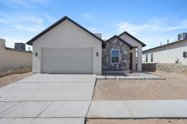 a front view of a house with garage and a garage