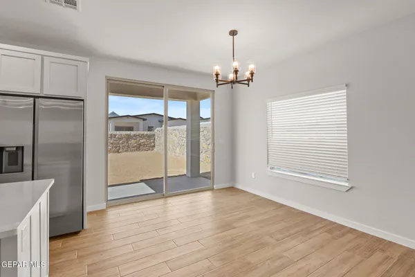a view of a room with a window and wooden floor