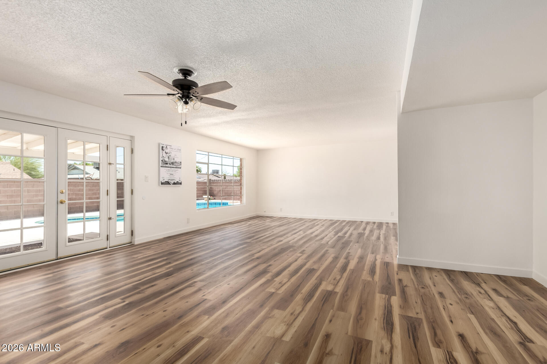 3913 West Krall Street Phoenix, AZ 85019 - Photo 13 of 35 wooden floor in an empty room with a window