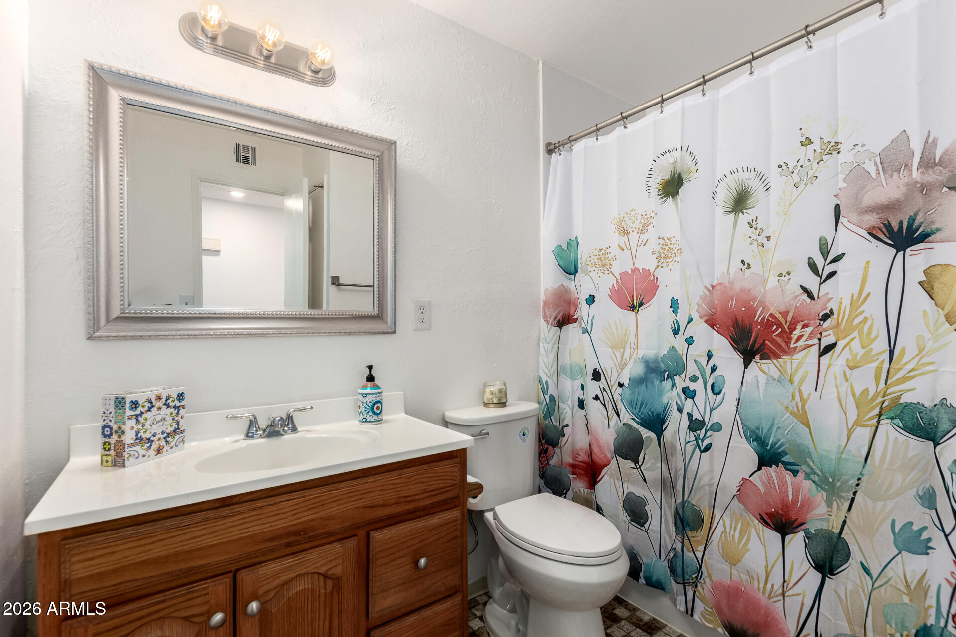3913 West Krall Street Phoenix, AZ 85019 - Photo 21 of 35 a bathroom with a sink mirror vanity and toilet