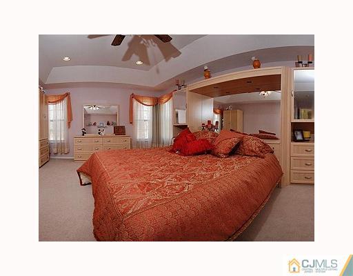 3 Stratton Road Old Bridge, NJ 07747 - Photo 7 of 10 a living room with a bed and mirror