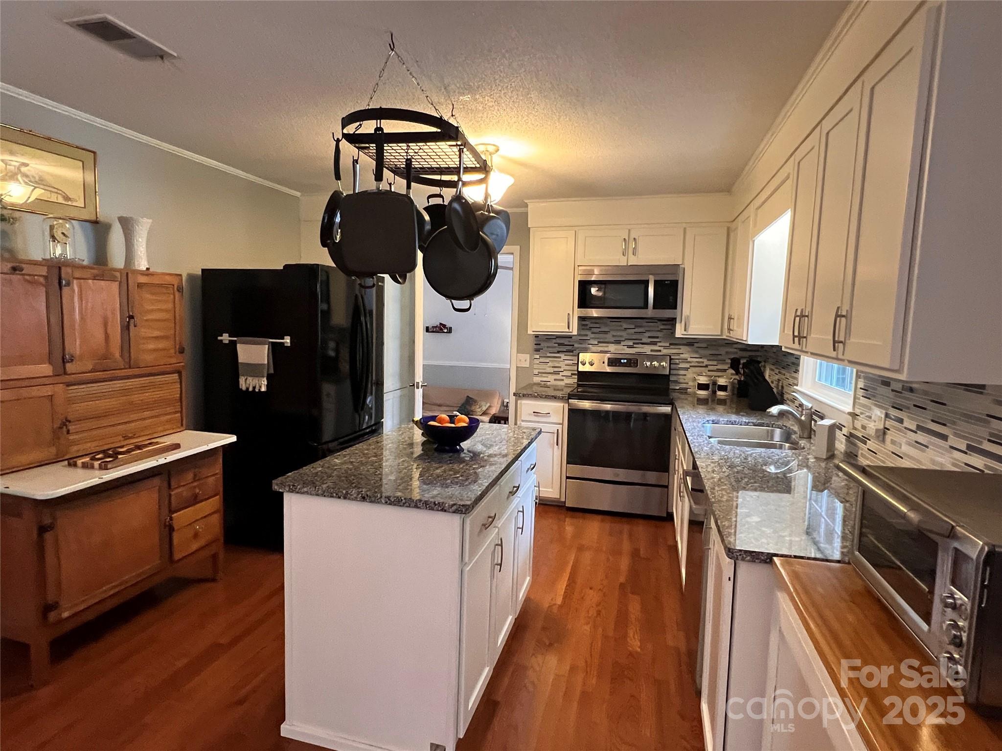 38430 Airport Road Albemarle, NC 28001 - Photo 19 of 39 a kitchen with stainless steel appliances granite countertop a stove top oven a sink dishwasher and a microwave