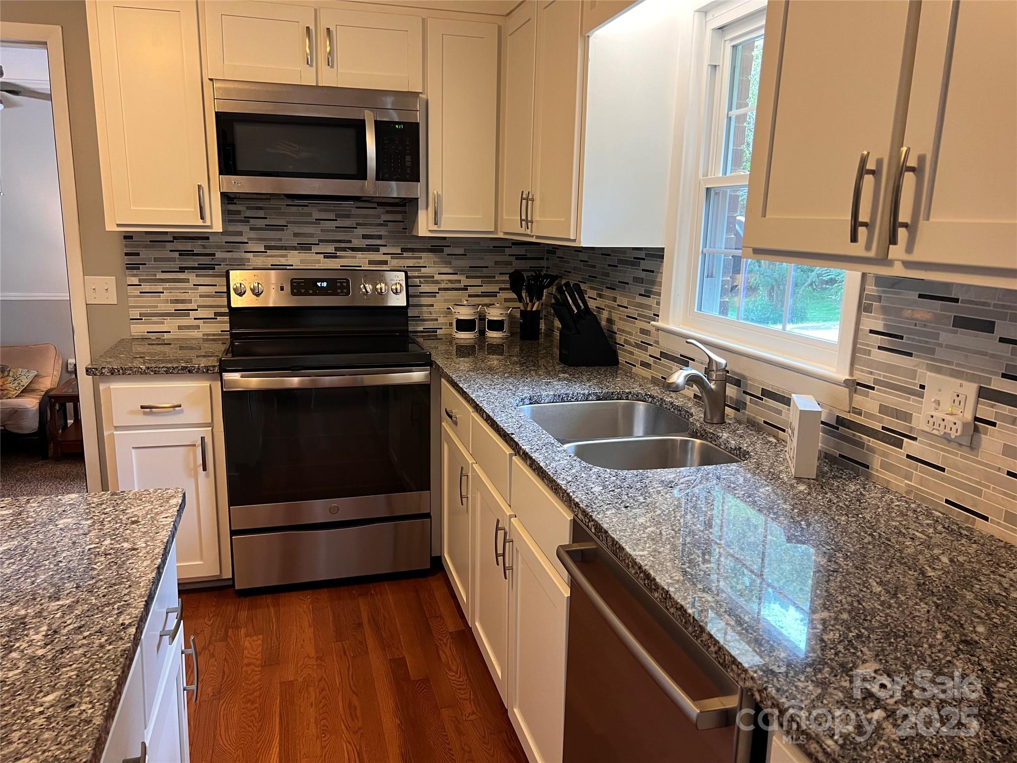 38430 Airport Road Albemarle, NC 28001 - Photo 21 of 39 a kitchen with stainless steel appliances granite countertop a sink stove and microwave