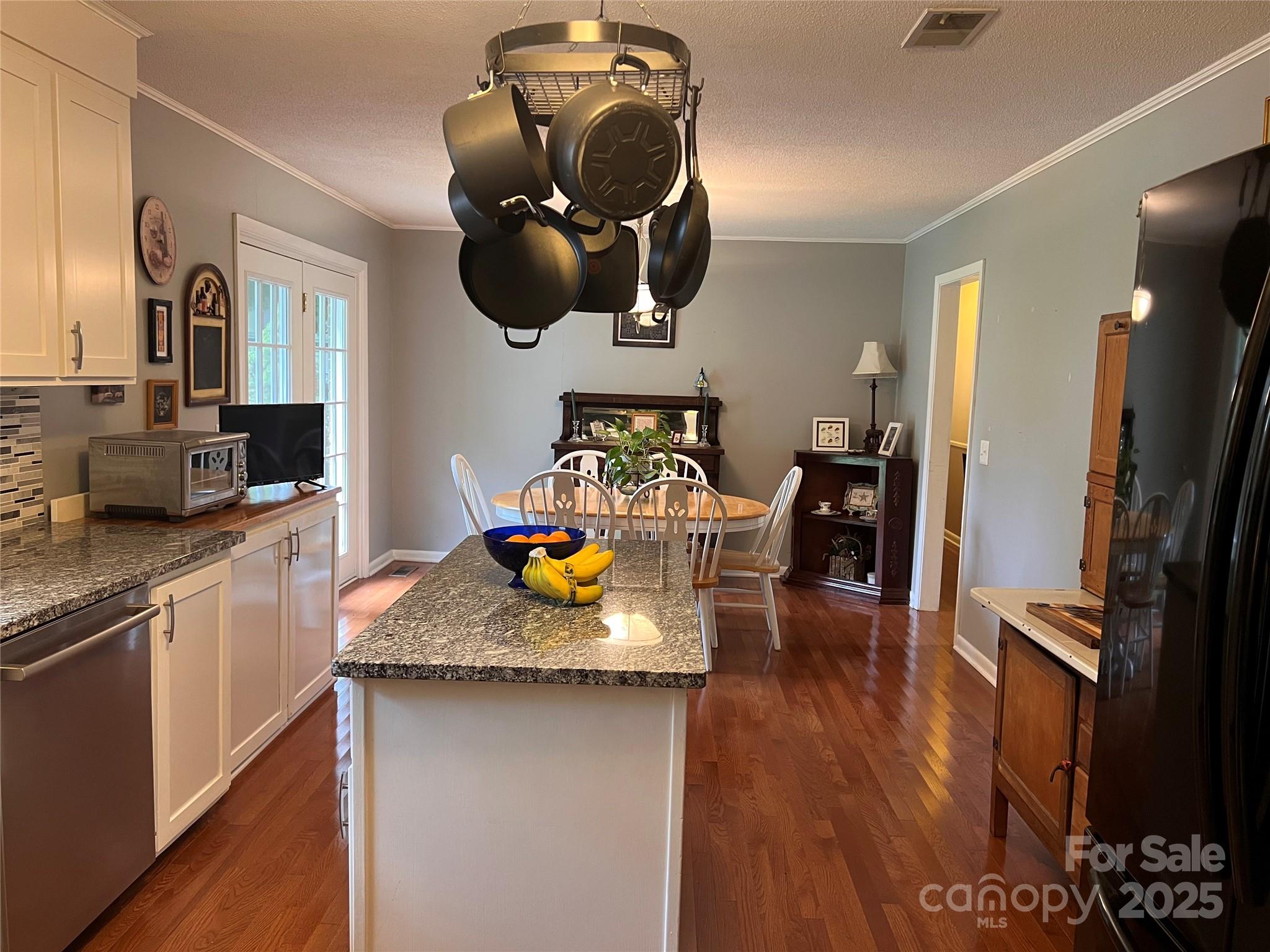 38430 Airport Road Albemarle, NC 28001 - Photo 23 of 39 a kitchen with stainless steel appliances granite countertop a sink dishwasher and a stove with wooden floor